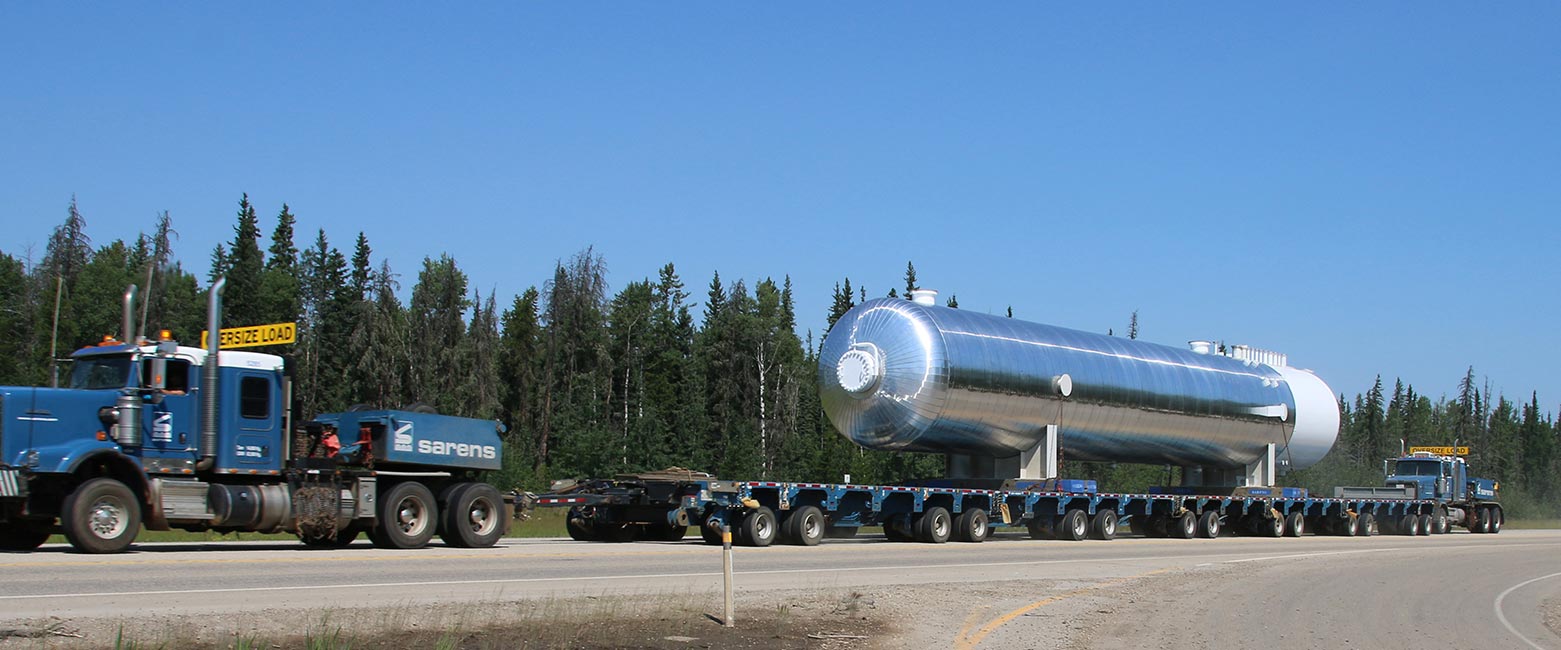 Image of Dynacorp fabricated vessel in transport on Alberta highway.
